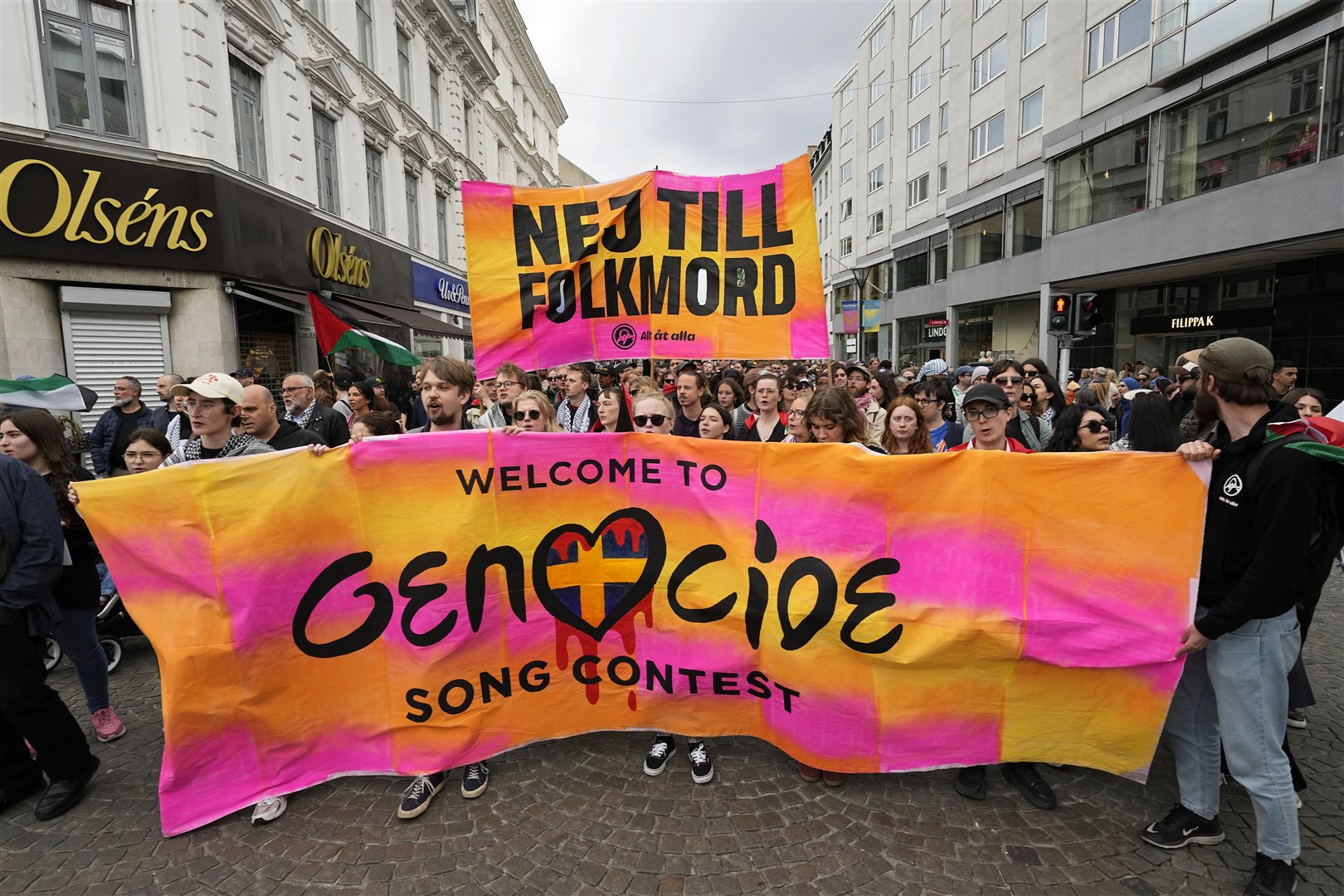 Protesters hold up a banner with the words in Swedish No To Genocide (Martin Meissner/AP)