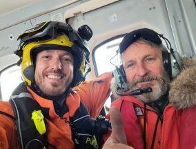 Cam Cameron (right) safely on board the Stornoway Coastguard search and rescue helicopter. Picture: HM Coastguard Stornoway